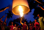 Bangladeshi Buddhists light a large paper balloon into the sky during Probarona Purnima in Ramu, Bangladesh. The Probarona Purnima festival celebrates the conclusion of the three-month long seclusion of the monks inside their monasteries for self-edification. Last year, on September 29th 2012 a muslim mob attacked and destroyed temples and homes of Buddhists after an anonymous person posted a photograph of a desecrated Quran on a local Buddhist boy's facebook wall. The community did not participate in Probarona Purnima last year in protest of the attacks. 