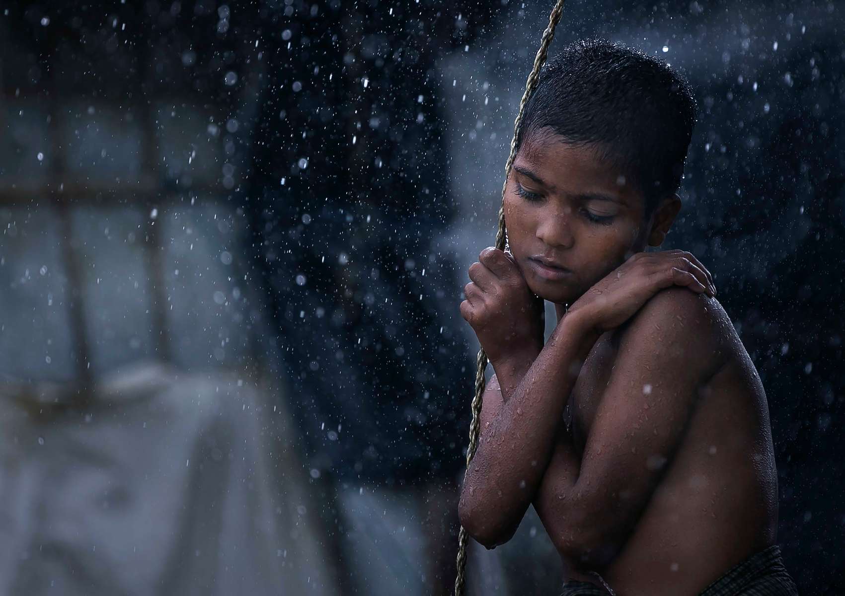 A Rohingya refugee is seen during a rainstorm at Nayapara refugee camp in Cox's Bazar, Bangladesh. Rohingya refugees said on August 21st that they did not want to return to Myanmar without their rights and citizenship, as repatriation is set to start on August 22nd. August 25th marks the second anniversary of the Rohingya crisis in Bangladesh. Myanmar's military crackdown on the ethnic Muslim minority forced over 700,000 to flee to Bangladesh from violence and torture. The United Nations has stated that it is a textbook example of ethnic cleansing. 