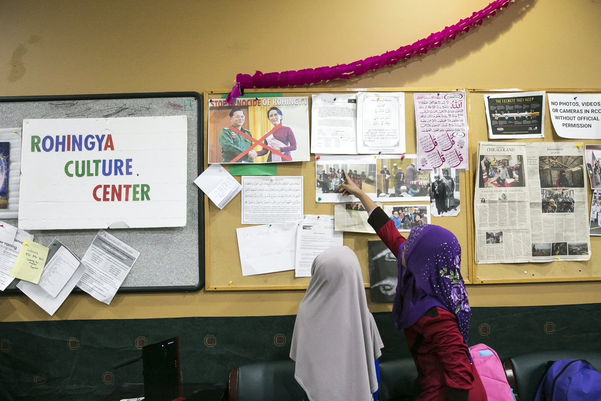 Children look at a bulletin board at the Rohingya Cultural Center of Chicago