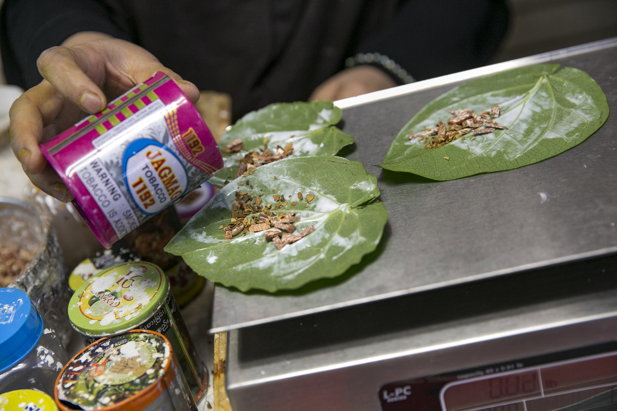 Nooraisha prepares paan leaf for customers at the Shwe Myanmar Grocery Store on January 11, 2019 in Chicago, Illinois. Nooraisha and her family escaped violence and oppression in Myanmar in 2000 to Thailand and then Malaysia, and was resettled in Chicago in 2010. She opened the Shwe Myanmar Grocery Store in 2017, and stock many products from Myanmar. 