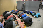 Children pray at the Rohingya Cultural Center of Chicago