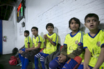 The Rohingya Cultural Center of Chicago soccer team watches teammates during a game 
