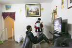 Feroz Shukor plays video games in his home on January 12, 2019 in Chicago, Illinois. The Shukor family arrived in Chicago in 2014 from Malaysia. Mohammad Shukor fled Myanmar in 1978 after the military shot him and arrested his father, who died in jail. He fled to Thailand by boat and spent 5 years there before making his way to Malaysia with his family. In Malaysia he and his family were denied an education, had to work illegally, and were frequently arrested and harassed by authorities. When he and his family were resettled in the US he says he {quote}felt so happy to finally have a country, to finally have a place to call home{quote}. 