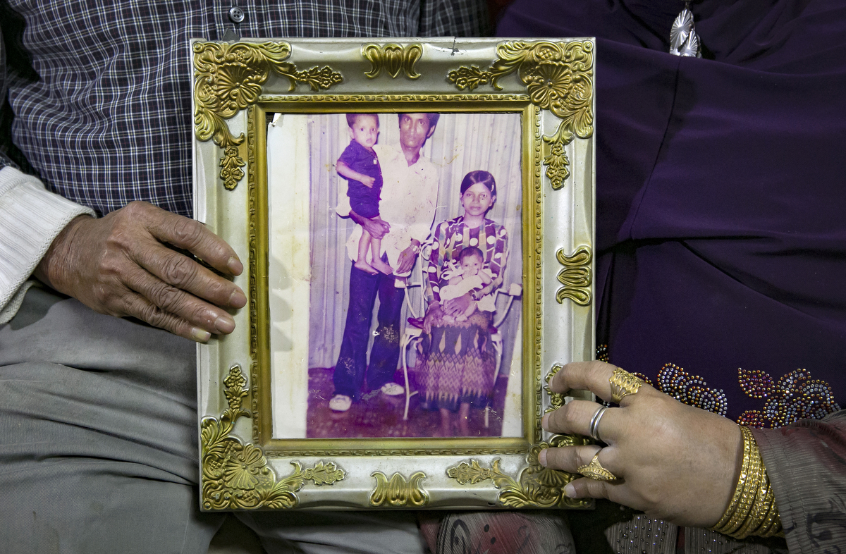 Mohammad Shukor and his wife Noor Jahan hold a photograph of themselves with two of their 11 children, taken in Thailand in 1980, on January 12, 2019 in Chicago, Illinois. The Shukor family arrived in Chicago in 2014 from Malaysia. Mohammad Shukor fled Myanmar in 1978 after the military shot him and arrested his father, who died in jail. He fled to Thailand by boat and spent 5 years there before making his way to Malaysia with his family. In Malaysia he and his family were denied an education, had to work illegally, and were frequently arrested and harassed by authorities. When he and his family were resettled in the US he says he {quote}felt so happy to finally have a country, to finally have a place to call home{quote}. 