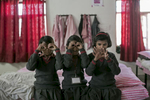 Priyanka, 11, (right red headband) plays with her friends before school at the Veerni Institute  