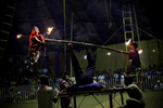 11 year old Sharif and 7 year old Nishan hold flaming sticks in their mouth as their father Mohammad Moshroom spins them on a pole during a performance at the Olympic Circus.