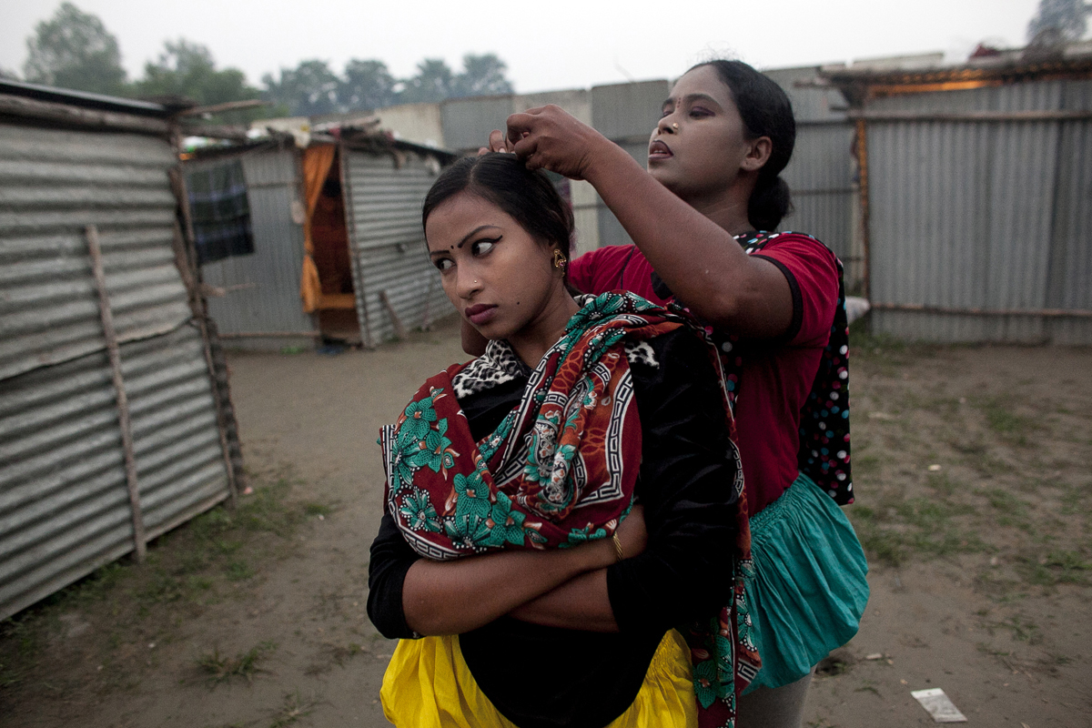 (L-R)16 year old Bristi Akhter has her hair checked for bugs by her mother, Sheuliy, in the residential area behind the Olympic Circus. She got married to her cousin last month, and she dropped out of school when she was 14 years old to start performing. Sheuliy, who doesn't know her age, got married to another circus worker when she was 10 or 11 years old. She never had a chance to go to school. 