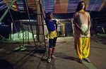 8 year old Puja Sarker looks at an older circus worker before she performs at the Olympic Circus. Puja was born into the circus, as were her parents, and never had the chance to attend school. 