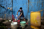 A clown washes dishes before a show at the Rambo Circus in Pimpri, India.