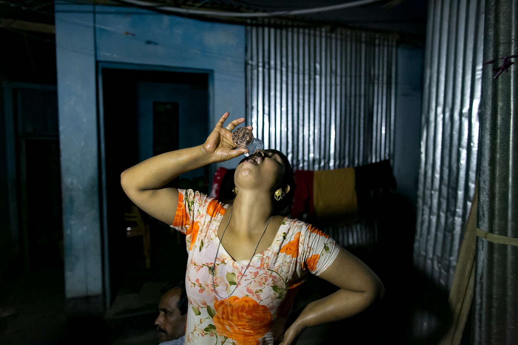 Sony drinks a shot of alochol in the brothel. Sony was married at 11 years old and trafficked to Daulatdia brothel when she was 13.‘I didn’t even know what sex was before I was married, but within a year of the ceremony, I’d been raped so many times I’d lost count. My mother-in-law would take my clothes off my body, then send me in to see her son. It didn’t matter how loudly I screamed. Nobody ever came to help me. But even when I stopped fighting back, it wasn’t enough to please my husband, and when my father admitted he couldn’t pay my dowry, I was sent back to my family. But the shame was too much – so they sent me away too. When a trafficker found me at a train station, she took me to the brothel where pimps beat me with hammers and vegetable peelers until I stopped trying to run away.None of my friends were married at my age, and none of them have had lives like mine. My father found me a husband because he thought village life was too dangerous for young daughters – there was so much harassment, and he feared that I might be attacked if I didn’t have a husband. But having a husband ruined my life. All I ever wanted was to go to college and get a good job, but that will never happen now. My sister is 21 and works for an NGO while studying for her Masters degree – she’s leading the life I always dreamed of. So I’m paying her school fees. Whenever I have a customer, I think, ‘it might be too late for me, but it’s not too late to help her.’