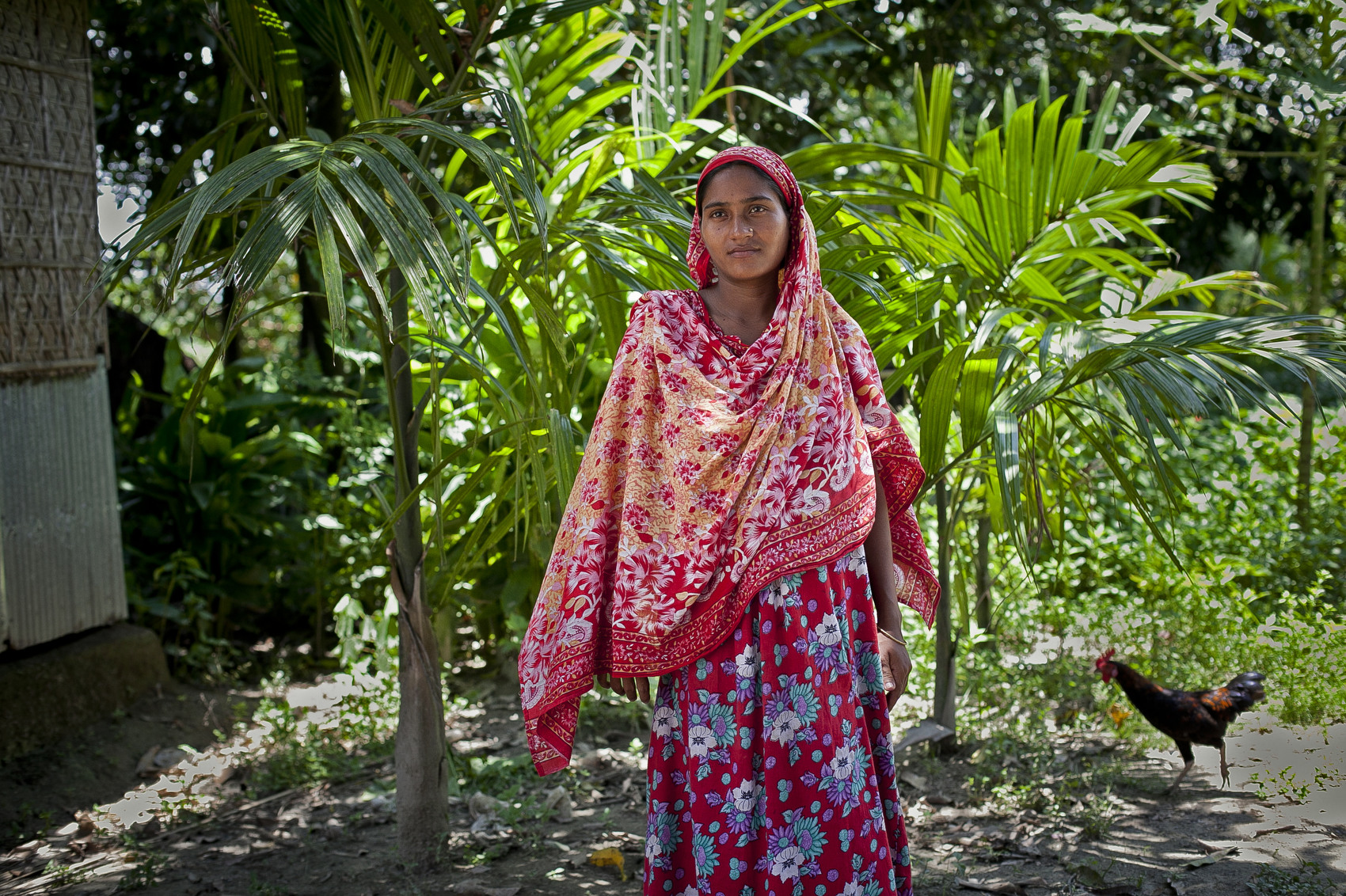LALMONIRHAT DISTRICT, BANGLADESH - JULY 9: Bash Kata Indian enclave resident, Musamat Lipi, stands for a photo after choosing Bangladeshi citizenship with the Enclaves Exchange Coordination Committee July 9, 2015 in Lalmonirhat District, Bangladesh. Lipi says that she is happy her son can go to school legally, now that they have citizenship. The India–Bangladesh enclaves, also known as the chitmahals, are 162 parcels of land, each of which happens to lie on the wrong side of the India/Bangladesh border. There are 111 such Indian enclaves in Bangladesh and 51 Bangladeshi enclaves in India. On June 6th Bangladesh and India came to an agreement to let residents choose which country they want to belong to, and on July 31st these enclaves will dissolve into the country already surrounding them. For decades, these people have been stateless. Both the Bangladesh and Indian governments have refused to take responsibility for the enclave residents. Their villages do without public services, they cannot vote, and parents must forge documents to send their children to schools. Until the Enclaves Exchange Coordination Committee came to their enclaves this month, most Indian enclaves residents had never laid eyes on an Indian national before. (Photo by Shazia Rahman/Getty Images)