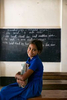 Afsana poses for a photo at KKS school near the brothel July 18, 2018 in Daulatdia, Bangladesh. Afsana, aged 10, lives in the brothel with her mother Tuli and her five-year-old brother Selim. Afsana loves school and is the second best student in grade three, despite her difficult living conditions. She loves studying Bangla and singing traditional songs but games in the playground with her best friend Razia are her greatest source of joy. She dreams of finishing school and finding a job to take her family out of the brothel. Photo by Allison Joyce / Save The Children