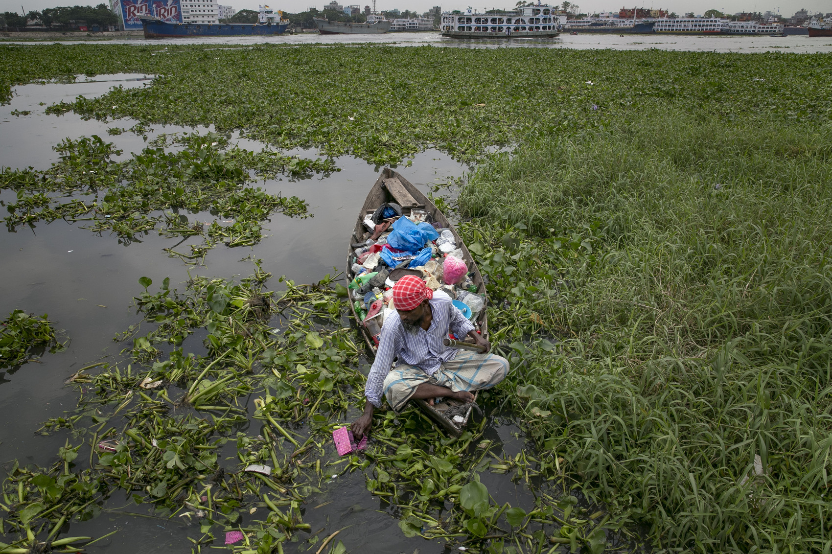 Firoz Milon collects waste on the Buriganga river in Dhaka, Bangladesh. He sells one kilo of waste for 20 taka and says he averages 400-600 taka per day of work. Bangladesh has been reportedly ranked 10th out of the top 20 plastic polluter in the world with the Buriganga river known as one of the most polluted rivers in the country due to rampant dumping of industrial and human waste. Like many developing countries, Bangladesh lacks the infrastructure to effectively manage their waste which causes problems in keeping the waters safe for human and aquatic lives while dozens of tanneries on the banks of the river contribute industrial waste into the ground water. As June 5 was marked by the United Nations as World Environment Day, Buriganga symbolizes the general state of many rivers in Bangladesh, with the growing levels of pollutants and plastic waste consuming up all oxygen in the river and affecting our seafood while fishes consume bits of plastic which mimics their natural food sources and eventually lands on our dinner table. 