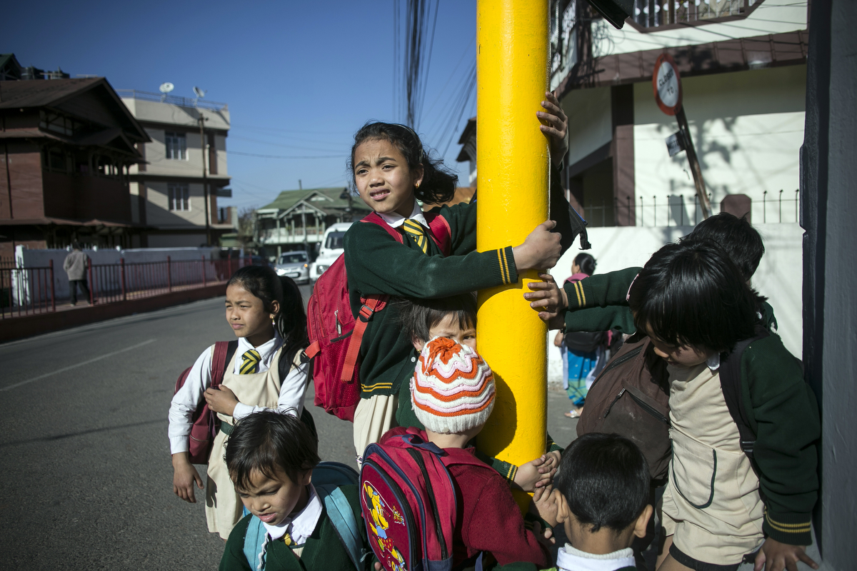 Girls wait for their school bus in Shillong