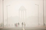 People walk near India gate amid heavy dust and smog in Delhi, India. People in India's capital city are struggling with heavily polluted air after low winds, holiday fireworks residue and crop-burning in neighboring states contribute to the haze, which has reduced visibility to 400 meters. The pollution levels have risen to 15 times more then the safe limit, a news reports said. Thousands of schools have been ordered closed, cricket matches canceled and residents warned to stay inside. The US embassy has said that it is {quote}very concerned{quote} about the impact of the pollution on Americans living in Delhi and the public at large. 
