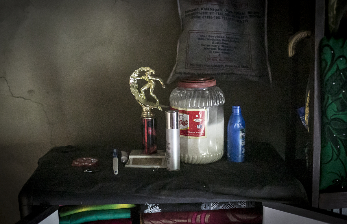 A surfing trophy sits in Soma's home 