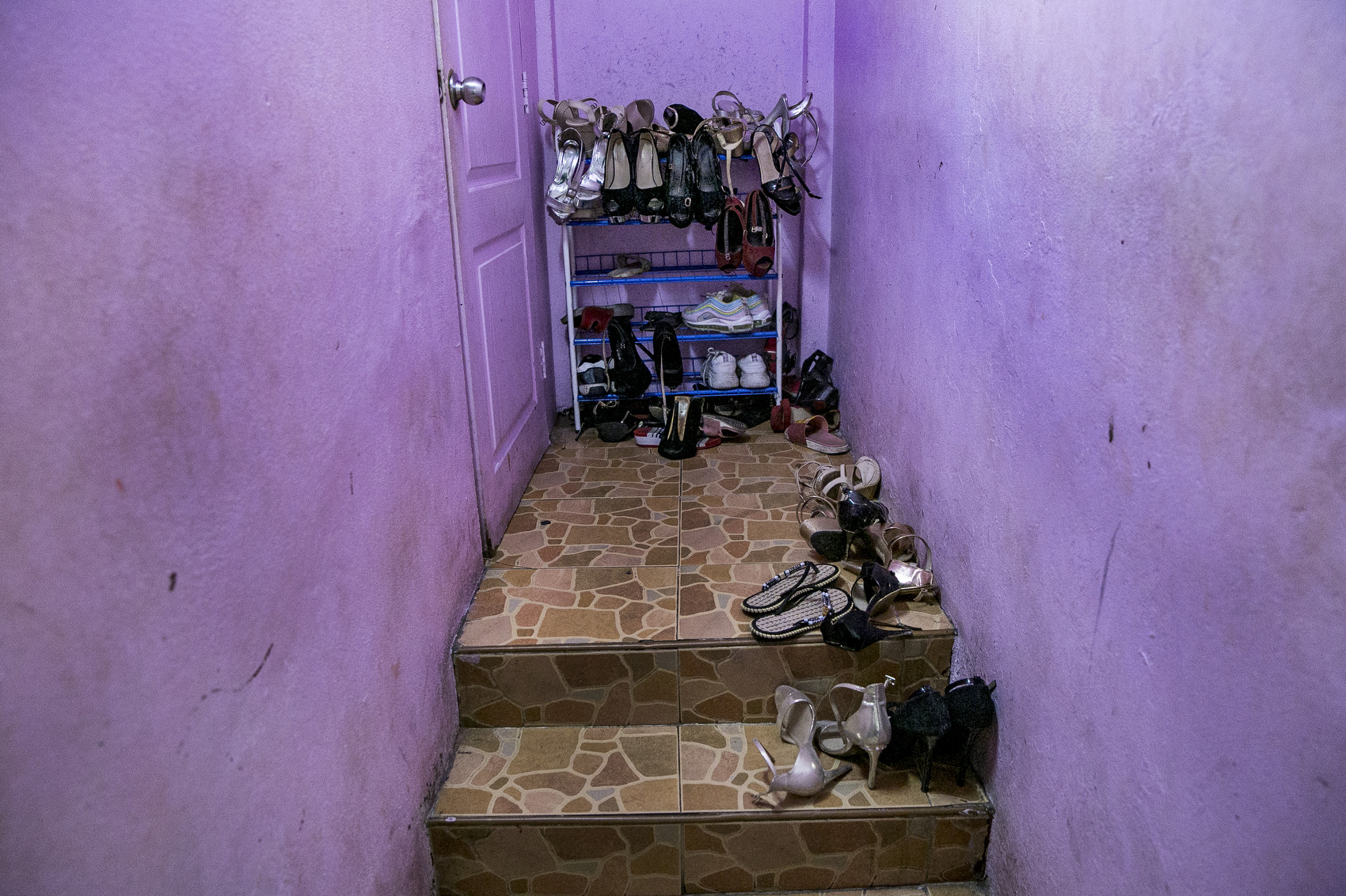 Shoes are seen the stairway by the living quarters in a bar in Pattaya , Thailand With entry into Thailand still restricted, and relatively few tourists able to enter, a good living has turned into a bad one for the country's sex workers.