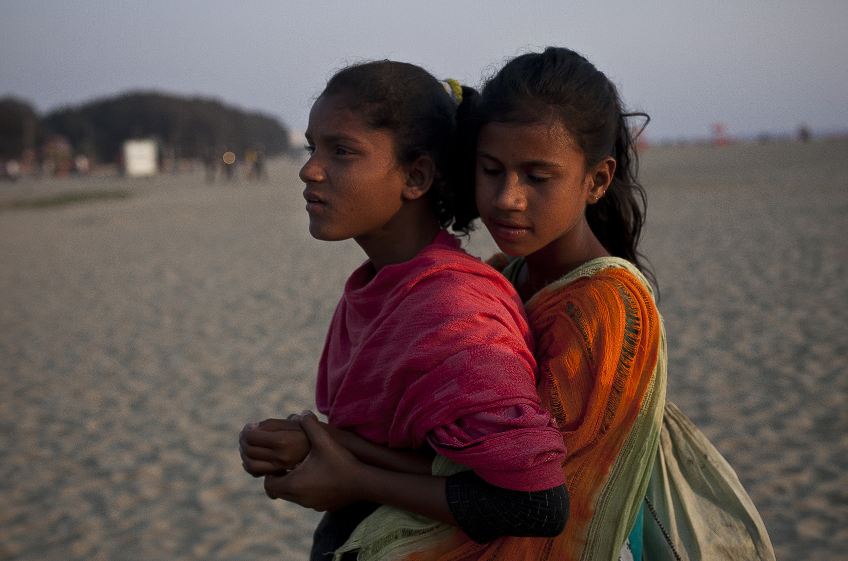 12 year old Shobe Majaraz hugs 12 year old Suma on the beach in Cox's Bazar, Bangladesh.