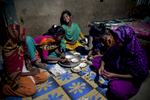 12 year old Maisha laughs in her home as she and the girls make jewelry to sell on the beach in Cox's Bazar, Bangladesh. 