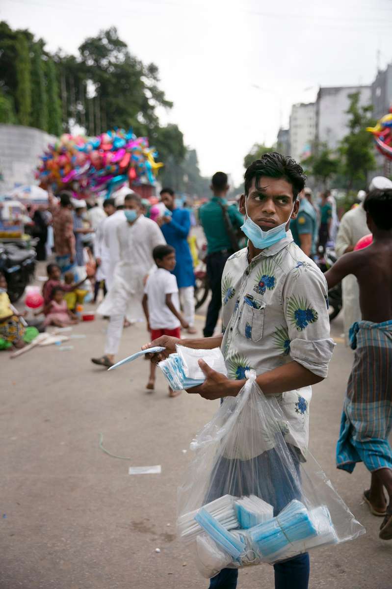 A vendor sells masks outside mosque after prayers on Eid day in Dhaka, Bangladesh.