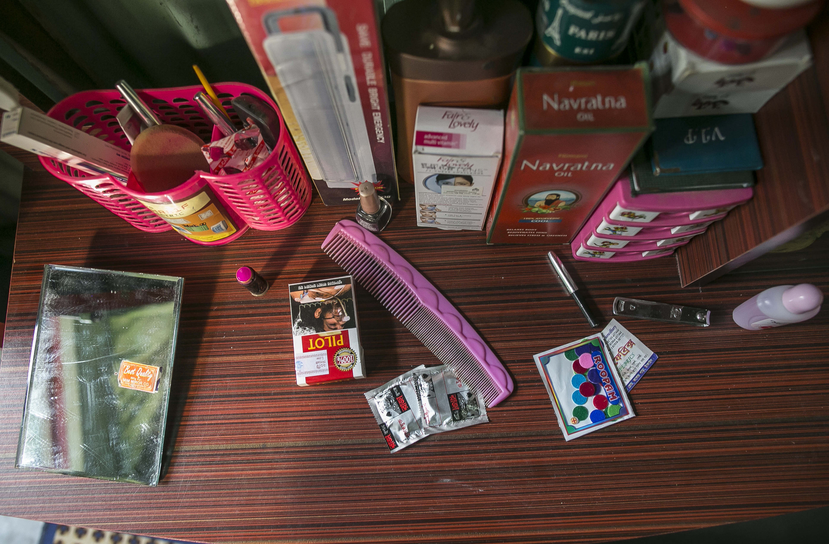 Condoms and cosmetic products sit on the table in Yasmin's room{quote}Yasmin{quote} was married at 11, trafficked to a brothel when she was 12.‘My husband married me without asking anyone’s permission. He already had a wife in her 20s or 30s, and one day she turned up at our house and invited me over to stay the night. When I got there, her husband locked me in a room and raped me, while she waited outside. After he was finished, he said that I had to marry him, because otherwise he would tell everyone that I was a bad girl who had sex with strangers. So he took me to the registry office, and I cried and cried as they signed the papers. When we got back to the house, he said that I had to have sex with his friends now too.I ran away, but a woman saw me crying, and offered to help. She fed me food and gave me water, but after a few mouthfuls I was suddenly really sleepy. I passed out, and when I woke up, we were at [a brothel]. She told me that while I was unconscious, she’d made a license in my name, and that I was a sex worker now.Escaping isn’t an option any more. My pimp used to lock me in my room from the outside, and she’d play loud music to drown out the sound of my screams as the customers raped me. I did try to run away 11 or 12 times, but she always caught me and beat me with a wooden stick until I was covered in bruises. She took away my clothes and gave me short dresses, so that if I did get out, everyone would instantly know I was from the brothel. Eventually, I stopped trying.I gave birth to twins last year, but one of them died from pneumonia two months ago. Now all I can do is try to save enough money to give my son a better future.’