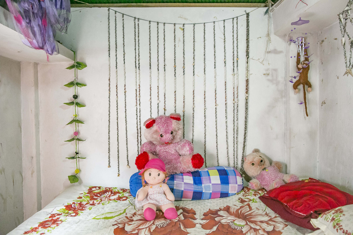The room of Namira is seen at a brothel. She was married at 14 and came to the brothel at 15. ‘My favourite thing in the world is my doll, Mimi. My mother bought her for me on Valentines Day this year. I used to have so many more dolls and teddies – like, what you can see here is nothing. My childhood was perfect. I wish I could goback in time and be a kid again. That’s definitely why I still have so many toys. It helps me pretend none of this is happening to me. My mum knows I work here, and she hates it, but there’s no alternative right now. She used to be a sex worker when she was my age too, so she understands how bad it is. But she also knows that sometimes, girls don’t get a choice. When I was 12, my father and brother died, and I went to stay with a new family to work as a maid. One of the sons would torture me – tying me up and raping me again and again and again. When I escaped and ran back to my mum, it wastoo late; I was already pregnant. Abortions are easy to arrange here, but afterwards, the only option is to get married to whoever will take you. The only man who would take me was a gambler who lost all the dowry in a bet. After the ceremony, he started torturing me so that my mum would agree to pay more in exchange for my safety – but she didn’t have any money. I think that was the moment when I knew I’d have to come here. I thought, ‘my life is already ruined – at least this way, I’ll be able to support myself.’ So I asked for a divorce, and took a rickshaw to the brothel. That was a year and four months ago – and I’ve regretted it every day since.’
