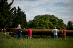 Members of the local batteau community came together to flip the Lizzie Langley over and load her onto a trailer for transportation to the James River.