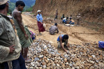 Laborers lay a base course of rough stone to the Namshan – Hsipaw road.  The road is the main artery for transporting tea south to the larger markets of Mandalay and Yangon.  Because the road is unpaved the majority of way, the short journey can easily take six hours in the dry season and much longer during the rainy season, when it becomes prone to landslides. 