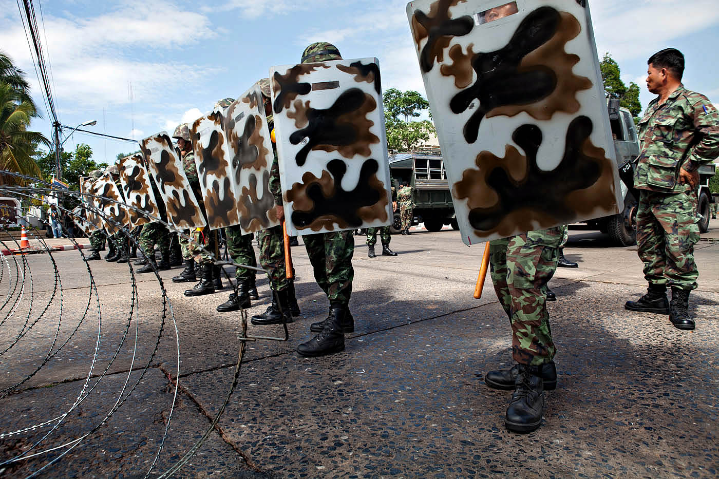 Udon Thani, Thailand. Riot police stand guard at a government office Wednesday, May 19, 2010 following a riot by anti-government protesters. The attack on the Thai government office came after TV showed reports of the crackdown on Red Shirt protesters in Bangkok. 