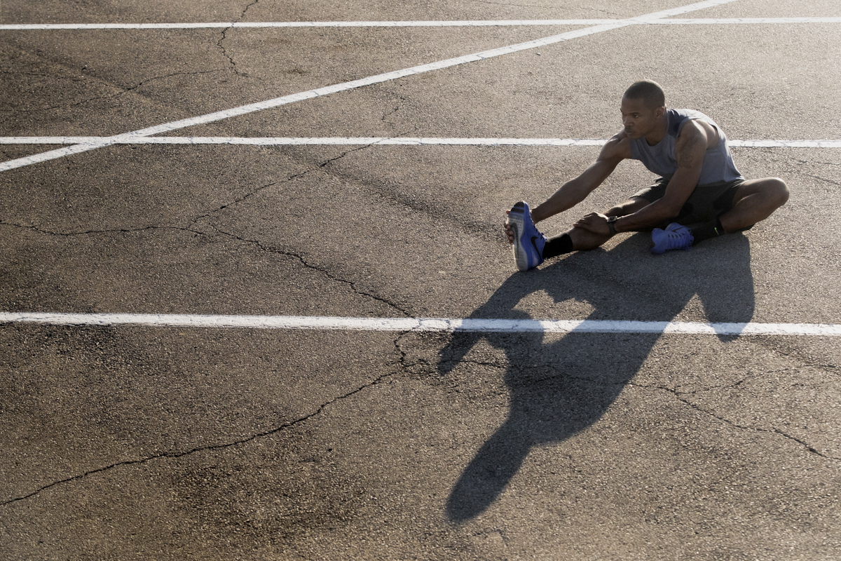 Stretching During Fitness Photoshoot shot by Austin, TX based professional photographer, Dennis Burnett