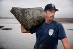 Editorial and portrait photography on location advertising oyster farmers.