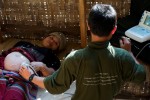 Saw Hsa Htoo, medical student at the Free Burma Ranger's Jungle School of Medicine, provides an ultrasound examination on an expecting mother who had never seen or been treated with ultrasound during her previous 3 pregnancies.  