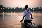 A young boy plays in the Mekong River, cooling off after a hot day during the dry season. 