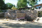 A site visit showing the inspection of a  pool, water feature, site grading and stone walls.