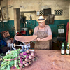 Photo of a Cuban man selling vegetables in his store in the Vedado district of Havana, Cuba.