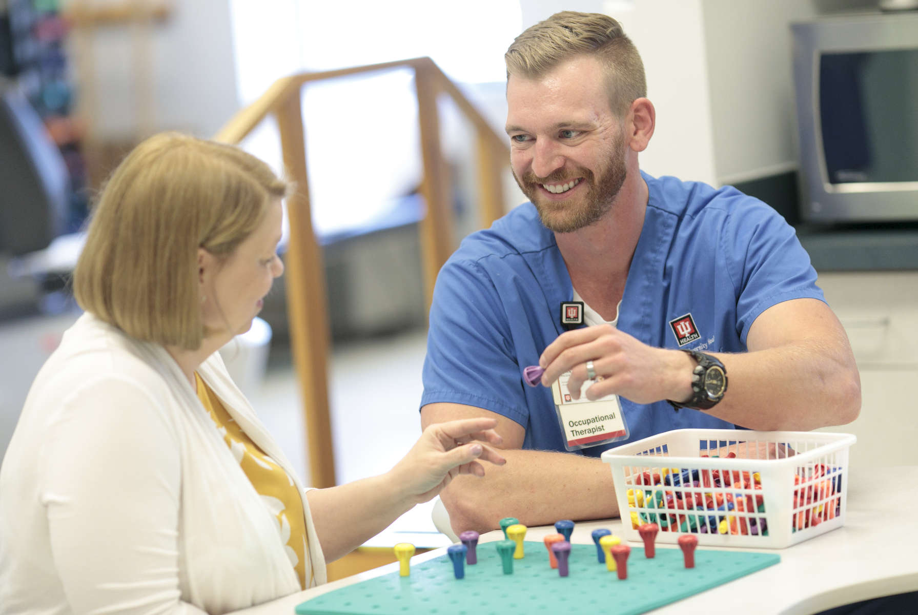 Occupational Therapist John Radzak works with a patient at IU Health Bloomington.