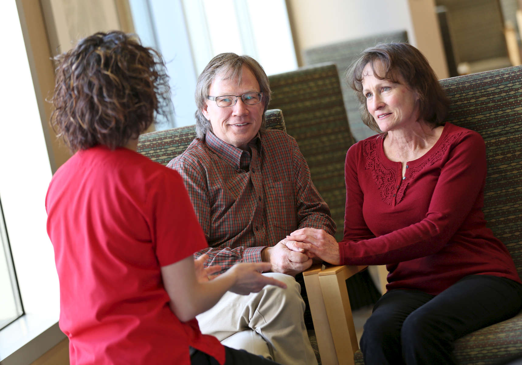 Patients Denise Ervin and Bill Hobbs talk to nurse Carey White at the IU Health Simon Cancer Center. 