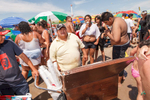 An estimated 75,000 people visited Coney Island on July 4th weekend, 2010. Food vendors cruise the east-west thoroughfare maneuvering their carts through the crowds at water's edge.