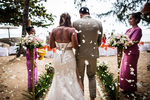 A bride is walked down the isle by one of her best friends at a beautiful beach wedding in Koh Samui, Thailand.