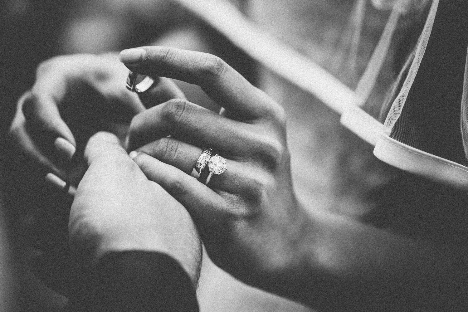 A bride and groom exchange rings during their wedding ceremony.