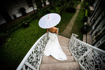 A young bride walks down an ornate staircase in Hanoi, Vietnam.