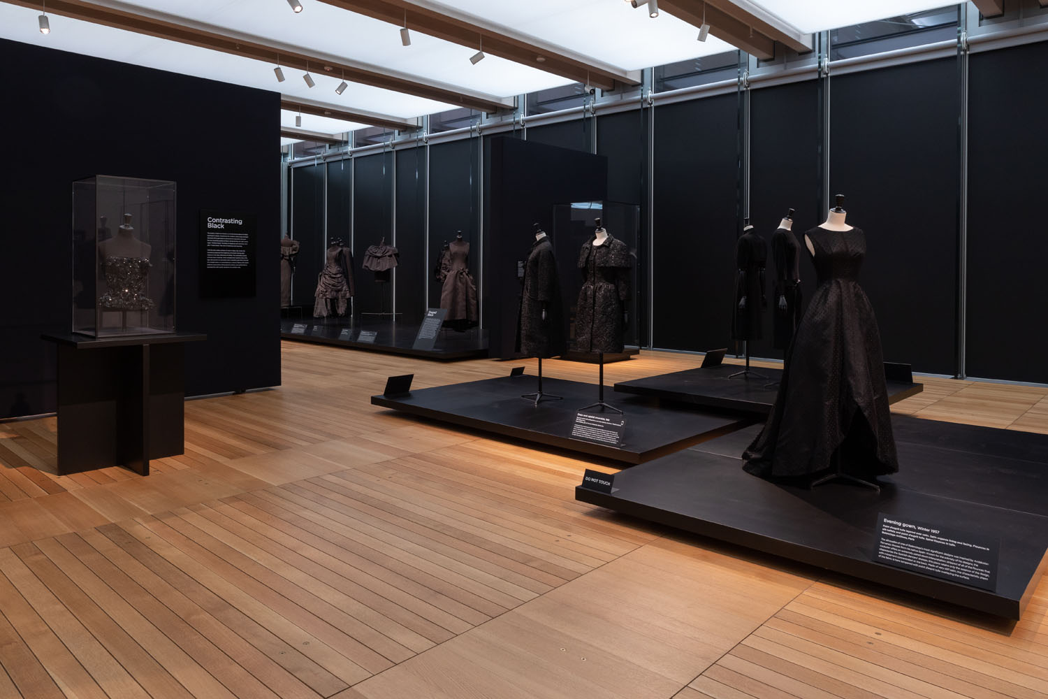 Balenciaga in Black at the Kimbell Museum was an overview of couturier Balenciaga’ s career from the 1940s to the 1960s. Over 100 pieces of hand made dresses were featured, including gowns, suits and accessories, all black. The goal of the exhibition design was to accentuate the various shapes, volumes, textures, and silhouettes of Balenciaga’ s timeless creations, and to encourage visitors to examine the exquisite detail in his work. Freestanding cases allowed for 36 0 degree, close-up viewing of the pieces, while cascading platforms enabled the composition of dramatic tableauxs. 