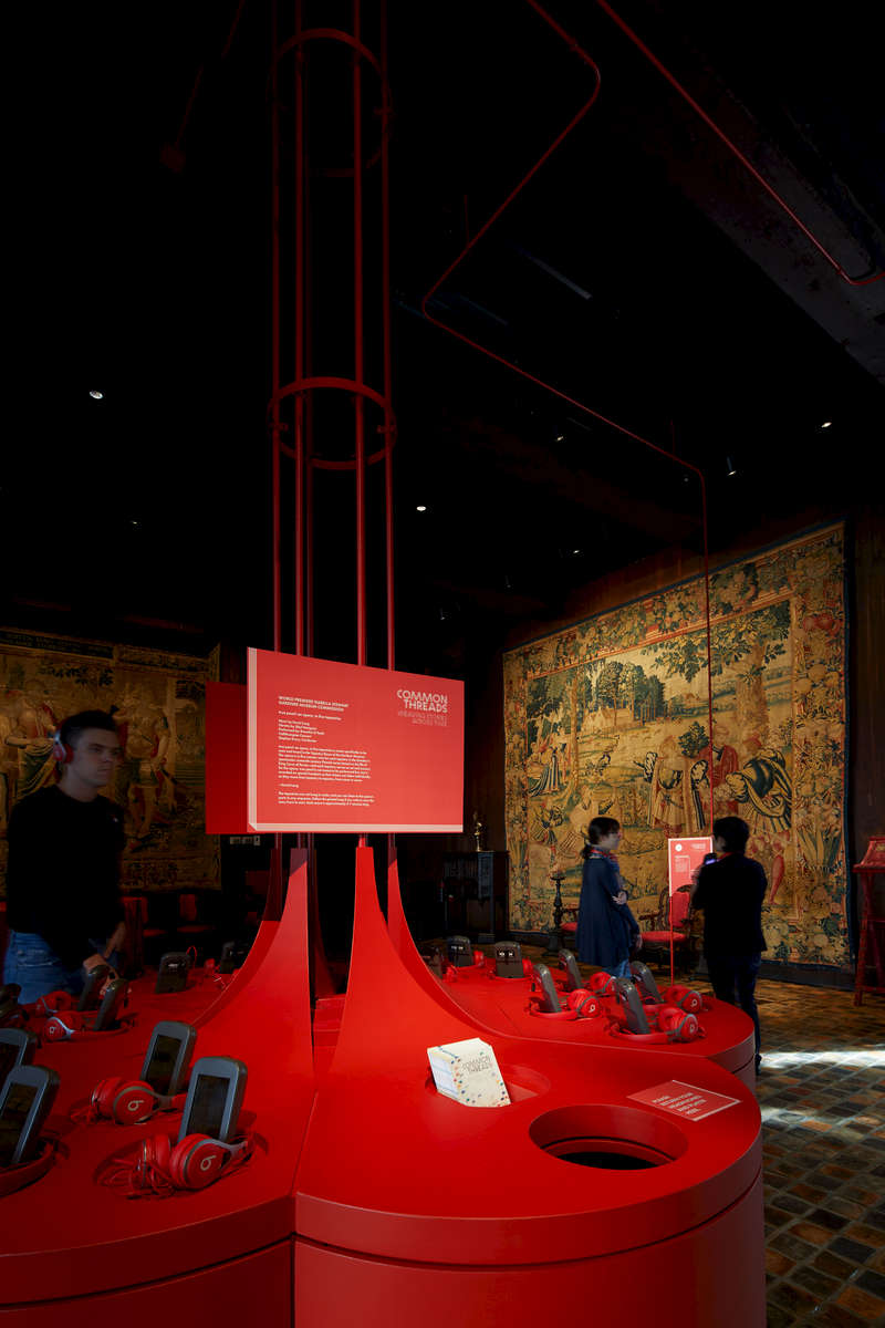 Common Threads: Weaving Stories Across Time featured a newly commissioned opera inspired by a set of 16th century Flemish tapestries. A table at the center of the gallery, designed to embody the opera’s lyrical qualities, functioned as a place where visitors could pick up headphones and watch an introductory video. “Threads” made of electrical conduit rose up from the center of the tabletop as if it was unraveling, and became label holders for each of the tapestries that were part of the opera. Since the opera itself had no form, the installation was able to give it physical presence. 