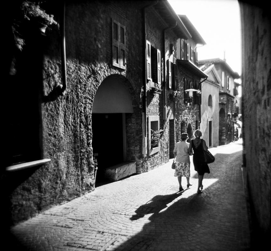 Women walk the streets of Sirmione on Lake Garda in Italy.