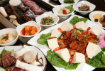 Banchan (complimentary starters) and the tofu kimchi pork bokum at Miga Korean BBQ Restaurant in Philadelphia.