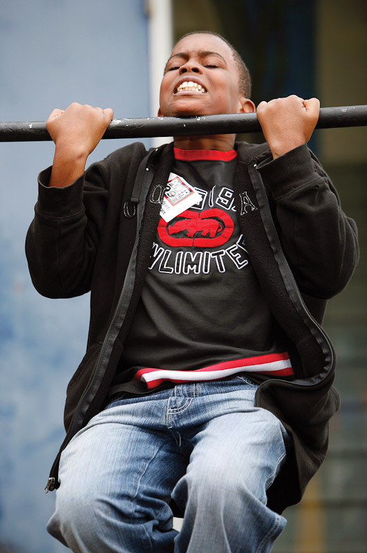 13-year-old Denroy Dunkley tries a chin-up at an Army recruitment station outside Franklin Field during the Penn Relays at the University of Pennsylvania.