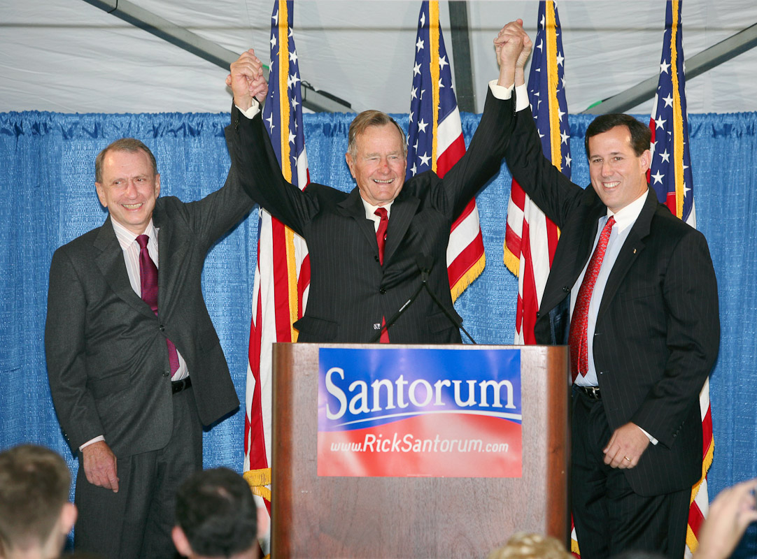 President George Bush Sr., center, raises the arms of Pa. republican senator Arlen Specter, left, and Pa. republican senatorial candidate Rick Santorum during a 2006 campaign rally at a private residence in Gladwyne, Pa.