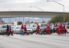 Santas cross a highway following the Santa Claus 5K in Las Vegas, NV.
