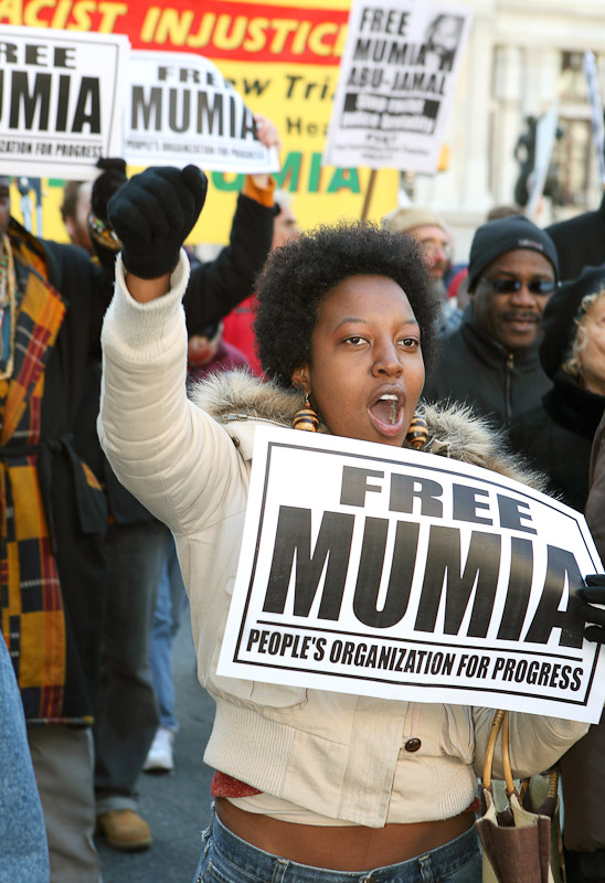 Georgette Kareithi marches through the streets of Philadelphia in support of death-row inmate Mumia Abu-Jamal during a protest marking the 25th anniversary of his incarceration for the murder of police officer Daniel Faulkner.