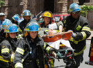 Paramedics rush to an ambulance with a survivor from a 4-storey building that collapsed in center city Philadelphia.